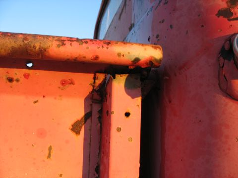 1952 Ford Pickup - Detail of corroded metal on a vehicle's exterior, showing signs of wear and age.