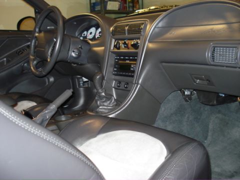 1998 Ford Taurus - Interior view of a car, showing the dashboard, seats, and gear shifter. The text 'SUPERMOTORS' is visible.