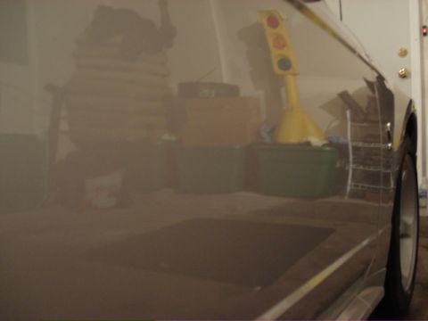 1998 Ford Taurus - The reflection on the car door shows a traffic light toy and various storage bins, with a Supermotors.net watermark visible.