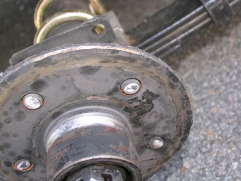 1995 Ford C-350 (Centurion Conversions) - Close-up view of a rusty wheel hub assembly, showing wear and tear on the metal components.