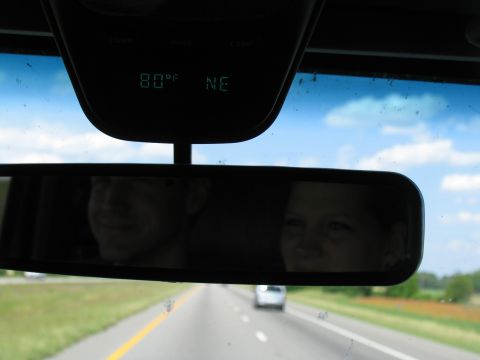 1995 Ford C-350 (Centurion Conversions) - Driving on the highway with a digital display showing 80 degrees and NE, with reflections of passengers in the rearview mirror.