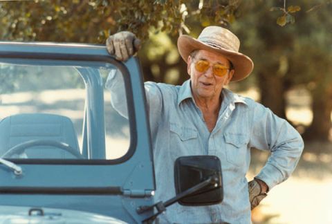 2000 Jeep Cherokee - Man in cowboy hat and sunglasses leans on the door of a blue Jeep.