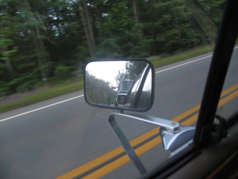 1995 Ford C-350 (Centurion Conversions) - Side mirror reflection shows a pickup truck on the road ahead.