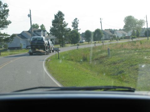1978 Ford Bronco - A 1978 Ford Bronco is transported on a trailer through a residential area.