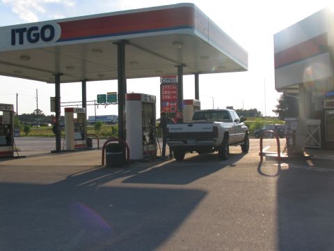 1978 Ford Bronco - A Dodge pickup truck is parked at a gas pump under a CITGO canopy during the day.