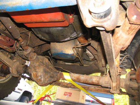 1978 Ford Bronco - The underside of a 1978 Ford Bronco shows its drivetrain, suspension, and a red object above the engine.