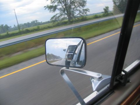 1978 Ford Bronco - A 1978 Ford Bronco is seen reflected in the side mirror while driving on the highway.