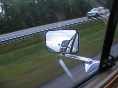 1978 Ford Bronco - A 1978 Ford Bronco is seen in the side mirror while driving on the highway.