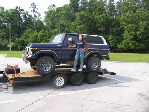 1978 Ford Bronco - A woman poses with a dark blue 1978 Ford Bronco loaded onto a trailer.