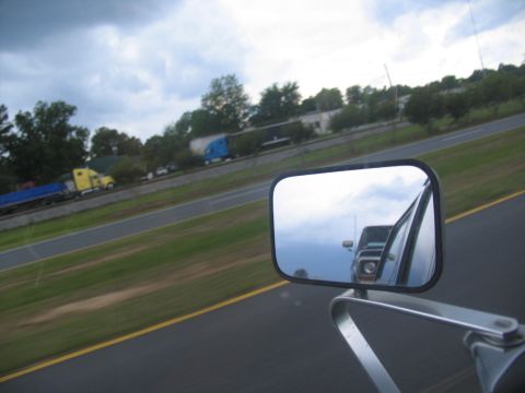 1978 Ford Bronco - Multiple trucks are seen on the highway, with one reflected in the side mirror.