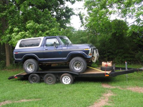 1978 Ford Bronco - A blue Ford Bronco is loaded onto a trailer, ready for transport.