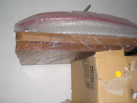 1995 Ford C-350 (Centurion Conversions) - Wrapped tail light assembly sits atop stacked cardboard boxes.