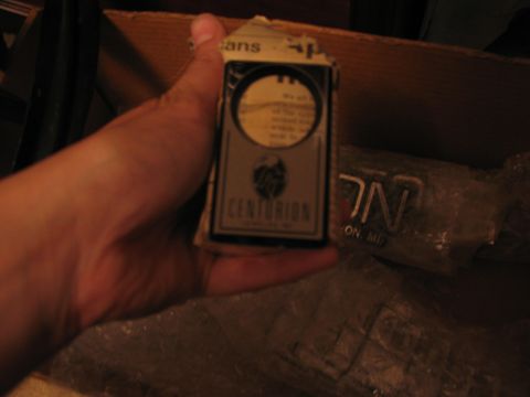 1995 Ford C-350 (Centurion Conversions) - Packaging for a Centurion part is held in a hand, with other items in the background.