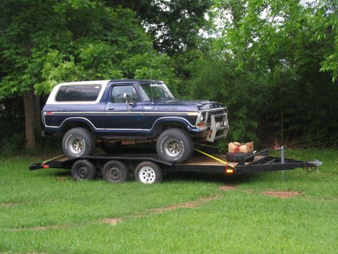 1978 Ford Bronco - A blue 1978 Ford Bronco is loaded onto a trailer, ready for transport.