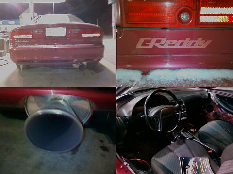 1993 Ford Probe - Rear view of a red coupe a large exhaust tip and GReddy badging on the rear panel.