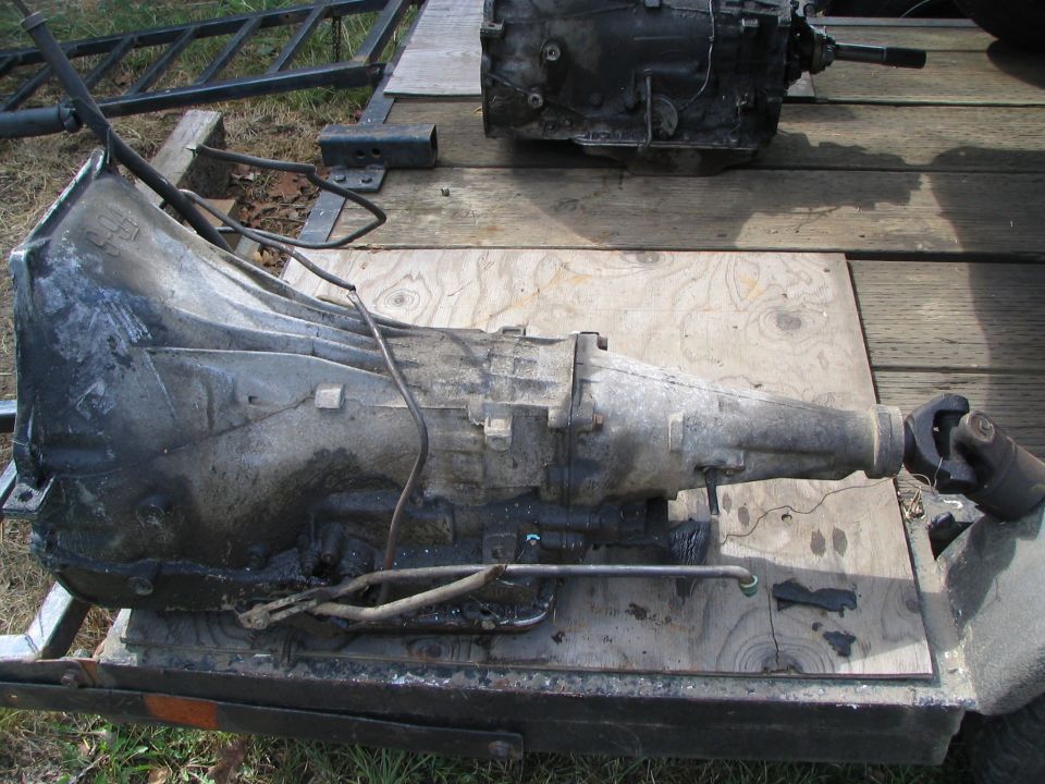 Two automatic transmissions sitting on a flatbed trailer