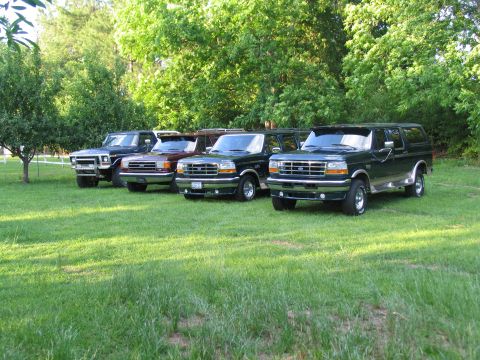 1995 Ford C-350 (Centurion Conversions) - A lineup of Ford Bronco Centurion Conversions, including a 1995 model, are parked on a sunny day.