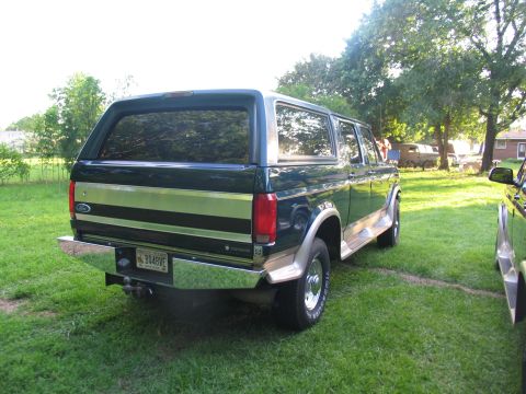 1995 Ford C-350 (Centurion Conversions) - This green Ford Bronco features a two-tone paint scheme with chrome accents and a rear bumper.