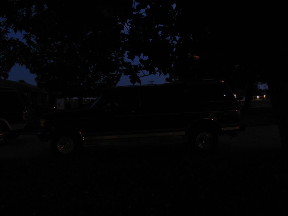 Side view of a dark SUV at dusk