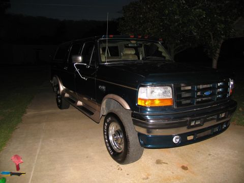 1995 Ford C-350 (Centurion Conversions) - Dark green 1995 Ford C-350 (Centurion Conversions) SUV parked outside at night.