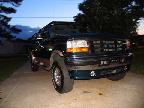 1995 Ford C-350 (Centurion Conversions) - This dark green SUV presents a 3q-front view, matching the 1995 Ford C-350 (Centurion Conversions) classification.