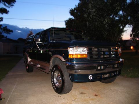 1995 Ford C-350 (Centurion Conversions) - Front 3/4 view of a 1995 Ford F-Series SUV, likely a Centurion Conversion, parked outdoors at dusk.