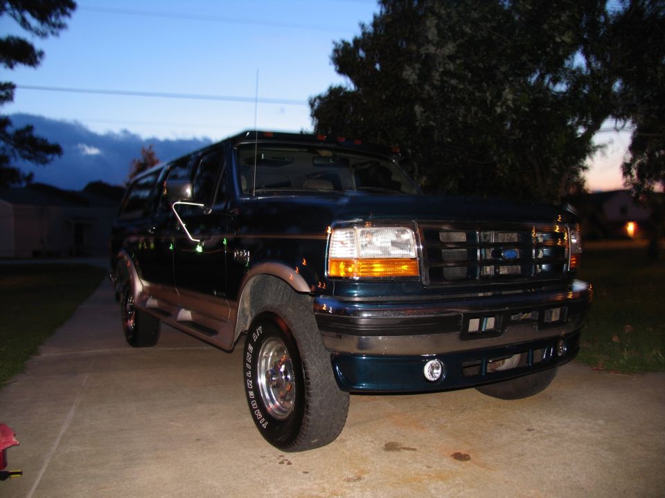 1995 Ford F-Series SUV, dark green with tan trim, parked on driveway