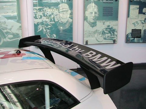 2007 BMW 8 Series - Rear spoiler with 'designed by BMW' text is visible on a white race car.