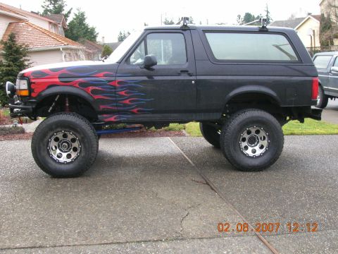 1996 Ford Bronco - This lifted Ford Bronco features custom flame decals and aftermarket wheels. The photo was taken on February 8, 2007.