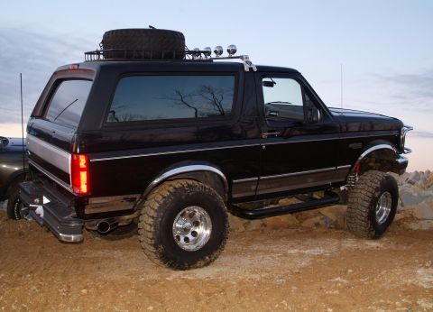 1995 Ford Bronco - This black 1995 Ford Bronco is equipped with a roof rack and a spare tire mounted on top.