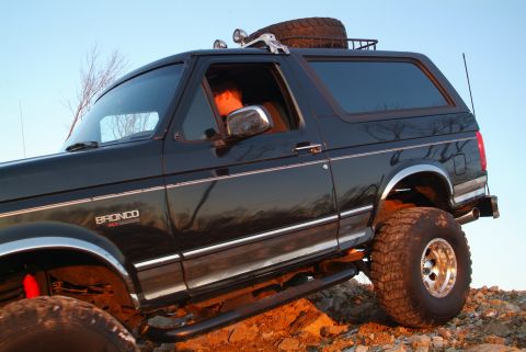 1995 Ford Bronco - This black 1995 Ford Bronco is equipped for off-road adventures with large tires and a spare tire on the roof rack.