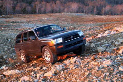 1995 Ford Bronco - A Toyota 4Runner navigates a challenging, rocky landscape during golden hour.