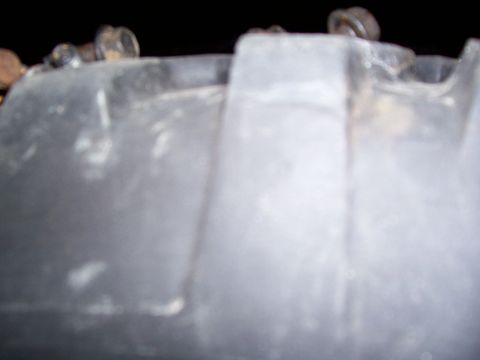 1985 Ford Bronco - A close-up view of a metal component, possibly from a vehicle, with a Supermotors.net watermark visible.