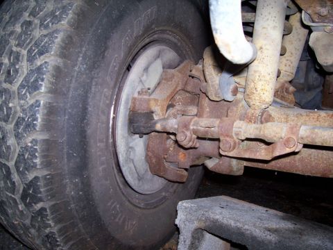 1985 Ford Bronco - This photo shows the front suspension components of a vehicle, including the wheel hub and steering mechanism.