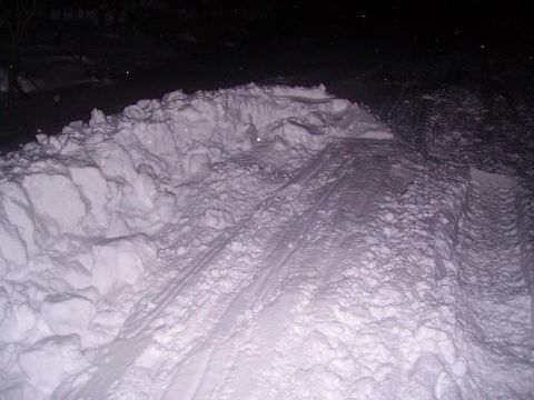2000 Chevrolet Tahoe - Tire tracks are visible in a deep snow scene at night.