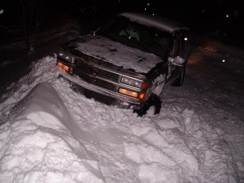 2000 Chevrolet Tahoe - Chevrolet pickup truck stuck in deep snow during a winter storm at night.