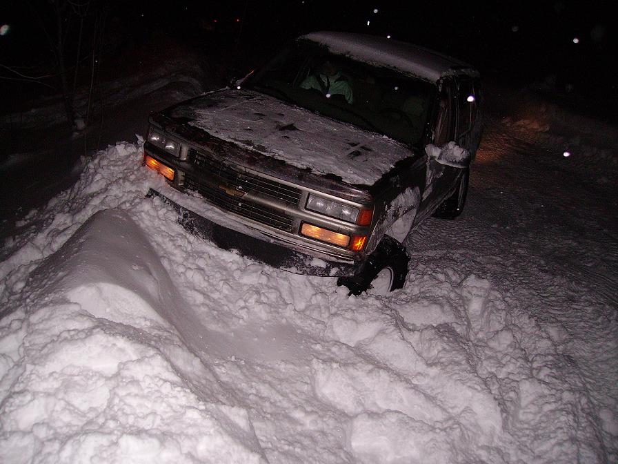 Chevrolet pickup truck stuck in deep snow at night