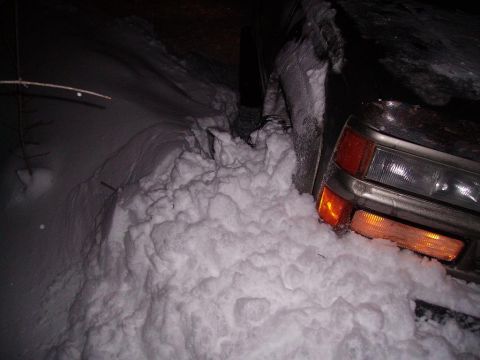 2000 Chevrolet Tahoe - Vehicle front end buried in snow, only headlights and turn signals are visible.