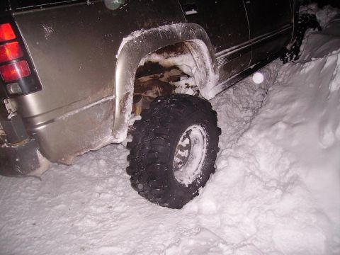 2000 Chevrolet Tahoe - This 2000 Chevrolet Tahoe appears to be stuck in a snowdrift, with its rear wheel partially submerged.