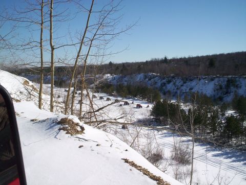 2002 Jeep Wrangler - Multiple red SUVs are visible in a snowy landscape, with a quarry and trees forming the backdrop.