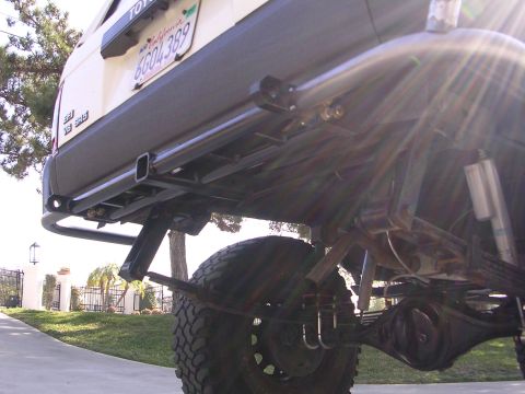 1985 Toyota 4Runner - This SUV has a custom rear bumper and suspension modifications, with a visible license plate.