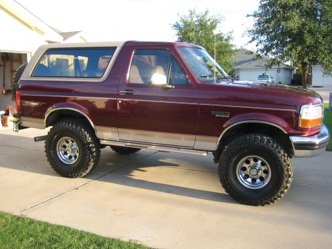 1996 Ford Bronco - This 1996 Ford Bronco features a two-tone paint scheme with a maroon body and a tan removable top.