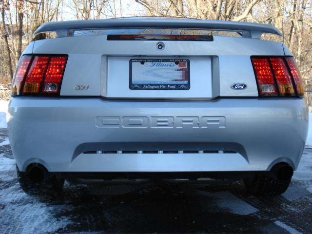 Silver Ford Mustang Cobra rear with SVT badging and "COBRA" embossed on the trunk