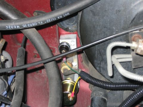 1996 Ford Bronco - Detail of engine bay components, including hoses and electrical wiring, with visible text on a black hose.
