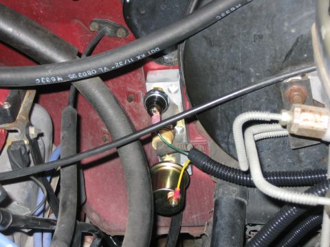 1996 Ford Bronco - Close-up view of a pressure sensor and associated wiring in a vehicle's engine bay.