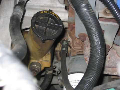 1996 Ford Bronco - Close-up of engine bay components including the power steering fluid reservoir.