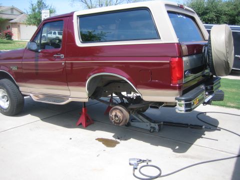1996 Ford Bronco - Rear wheel removed from a 1996 Ford Bronco, which is supported by jack stands.