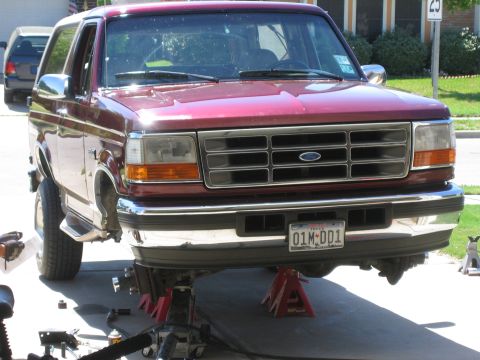 1996 Ford Bronco - Front view of a 1996 Ford Bronco being worked on, lifted on jack stands.