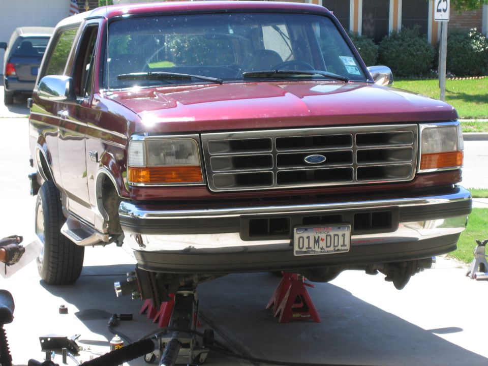 1996 Ford Bronco front view, raised on jack stands for maintenance