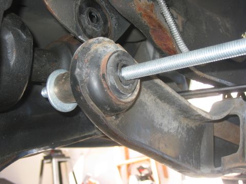 1996 Ford Bronco - Suspension component with a threaded rod installed, likely part of a lift kit modification.